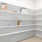 a white shelving unit with boxes and boxes on it