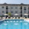 a swimming pool in front of a large building