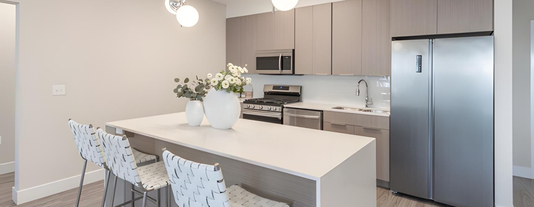 a kitchen with an island and chairs