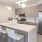 a kitchen with an island and chairs