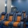a room with a blue wall and orange chairs
