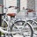 a row of bicycles parked on a sidewalk