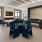 a room with a table chairs and a large window