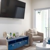 living room with chairs, coffee table and tv