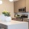 a kitchen with a white counter top and a white pot with yellow flowers